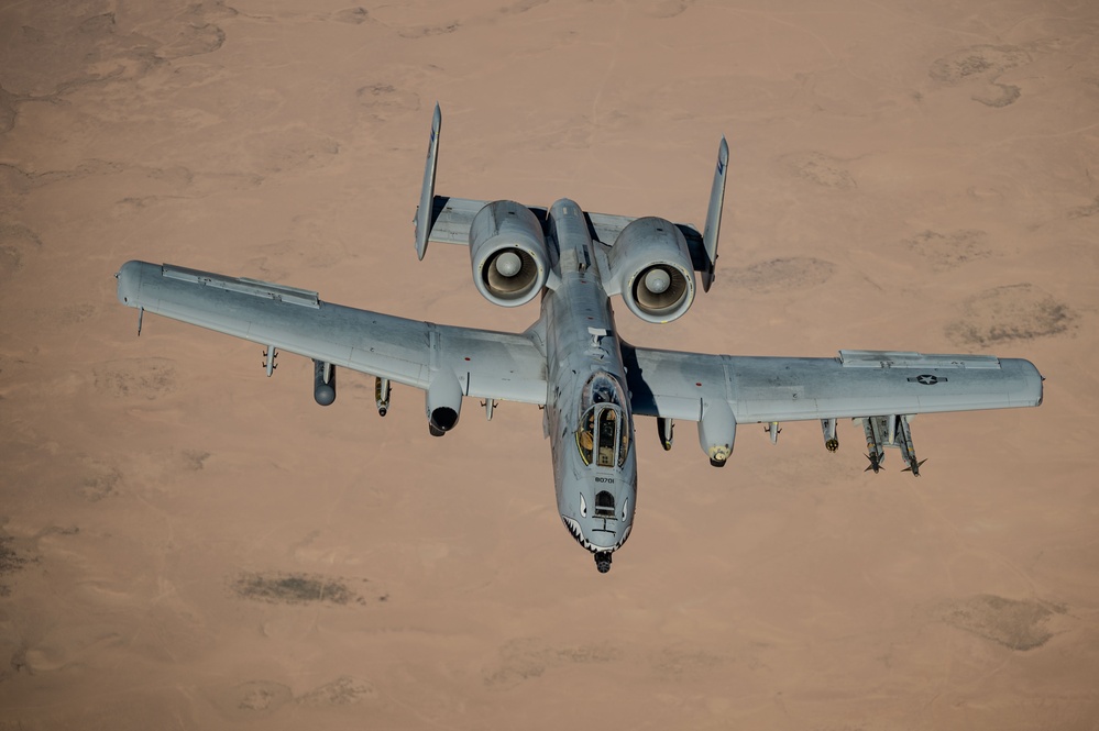 A-10 Thunderbolt II flying at low altitude over terrain