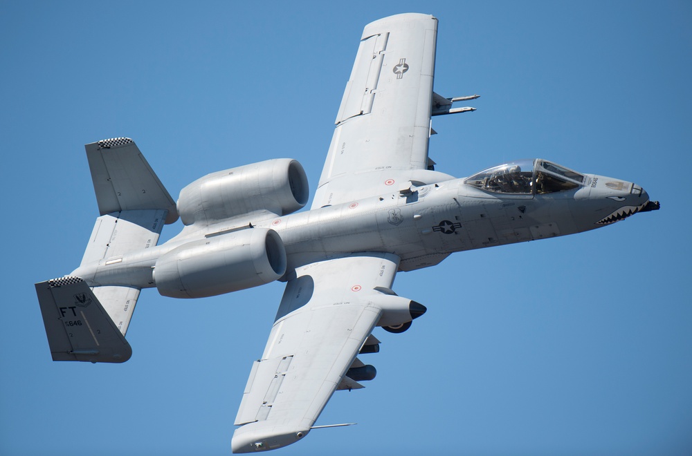 A-10 Thunderbolt II aircraft soaring through clear blue sky