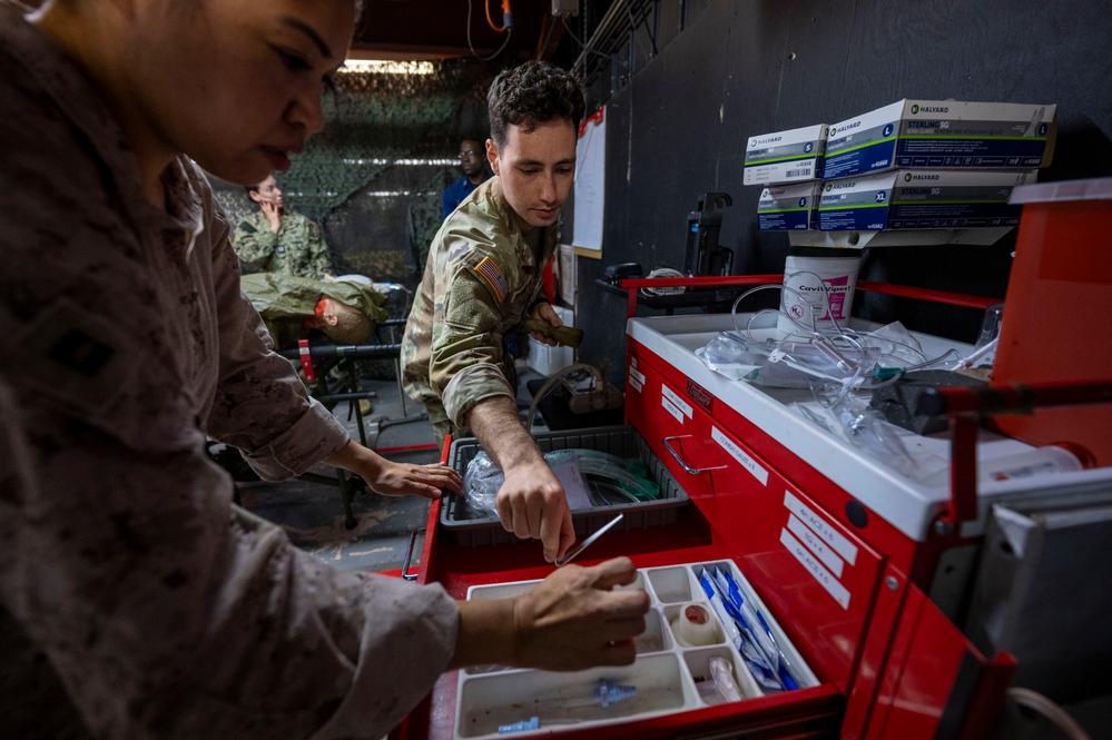 Military medical personnel participating in advanced tactical training