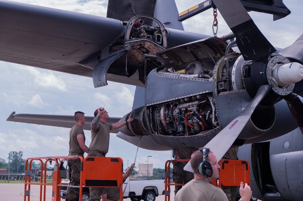 Airmen replacing an engine on a C-130 Hercules aircraft