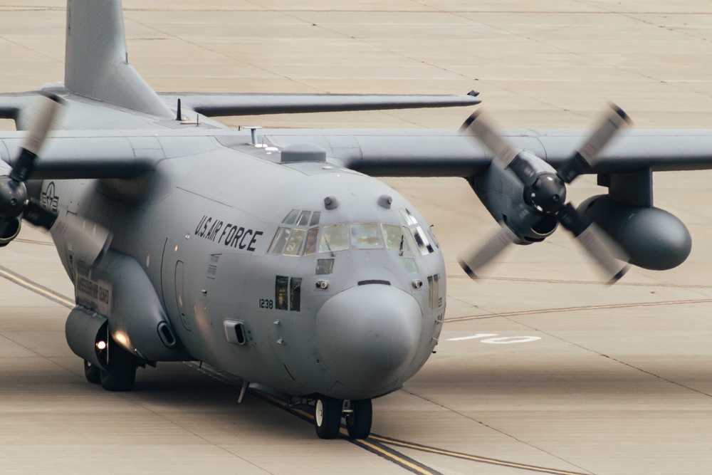 Seven C-130 Hercules aircraft flying in formation over Missouri