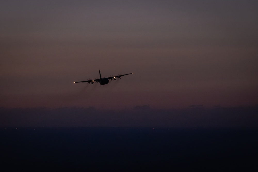 C-130 Hercules flying at sunset during special operations mission
