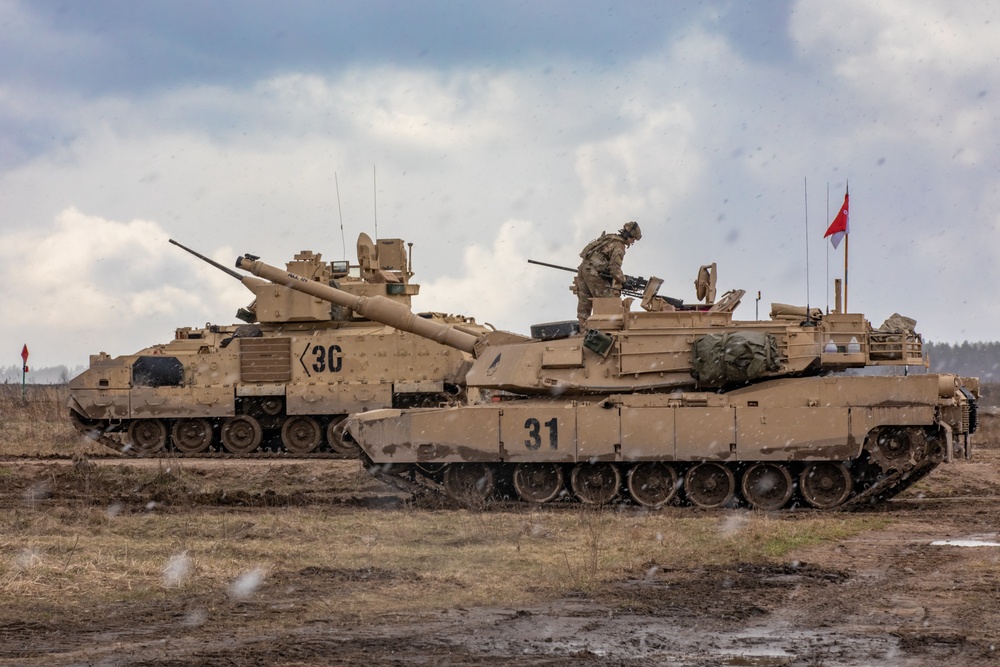 German Leopard tanks and U.S. M1 Abrams tanks operating together during combined training in Poland