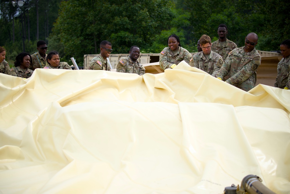 Petroleum supply specialists setting up collapsible fuel bags during training