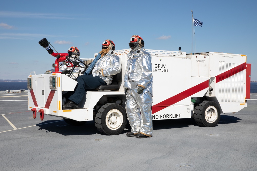 Sailors onload ammunition aboard USS Iwo Jima