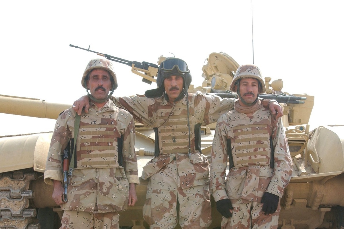 Soldiers standing with their T-72 tank
