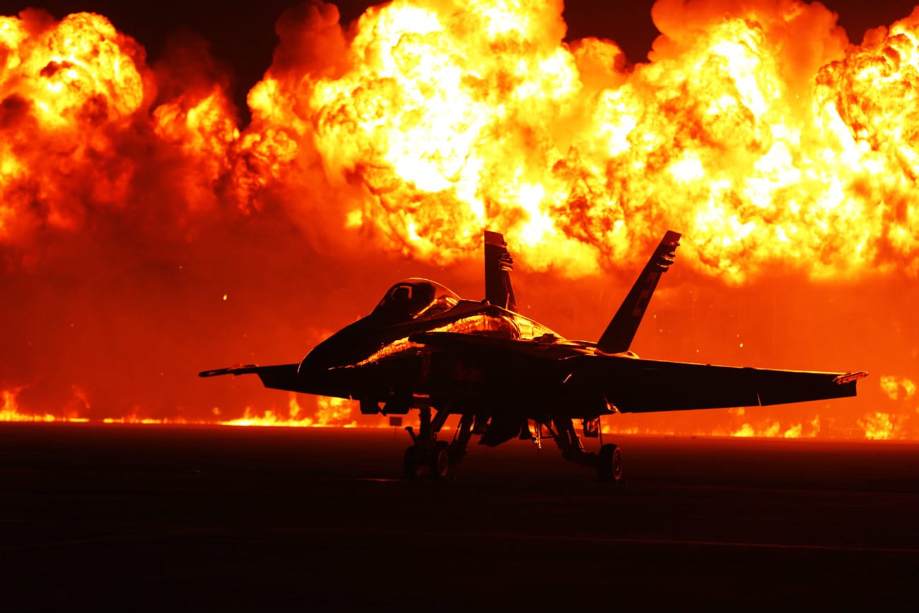 US Military Aircraft at Night Images - FA-18 Hornet with flames in the background