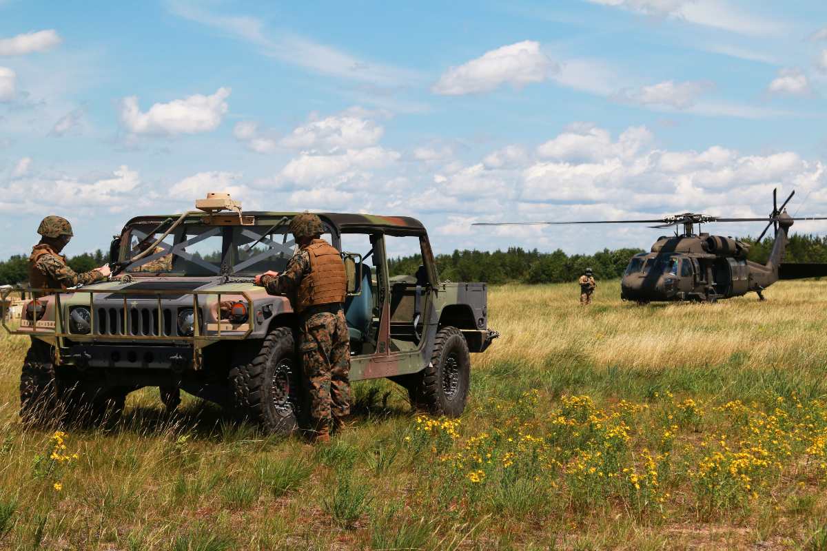 Members of the U.S. Marine Corps Forces Reserve Landing Support Company, Combat Logistics Regiment 45 prepare a high mobility multipurpose wheeled vehicle (HMMWV) for sling load operations during Northern Strike 19 on Camp Grayling, Michigan, July 21, 2019. Northern Strike 19 is a National Guard Bureau-sponsored exercise uniting service member from more than 20 states, multiple service branches and numerous coalition countries during the last two weeks of July 2019 at the Camp Grayling Joint Maneuver Training Center and the Alpena Combat Readiness Training Center.